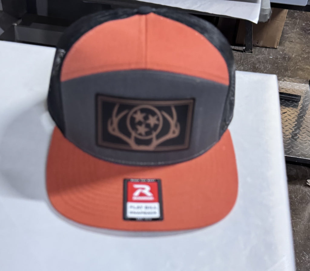 Richardson 168 - 7 Panel Trucker Hat – Charcoal/Burnt Orange/Black - Custom Leatherette Patch w Your Logo